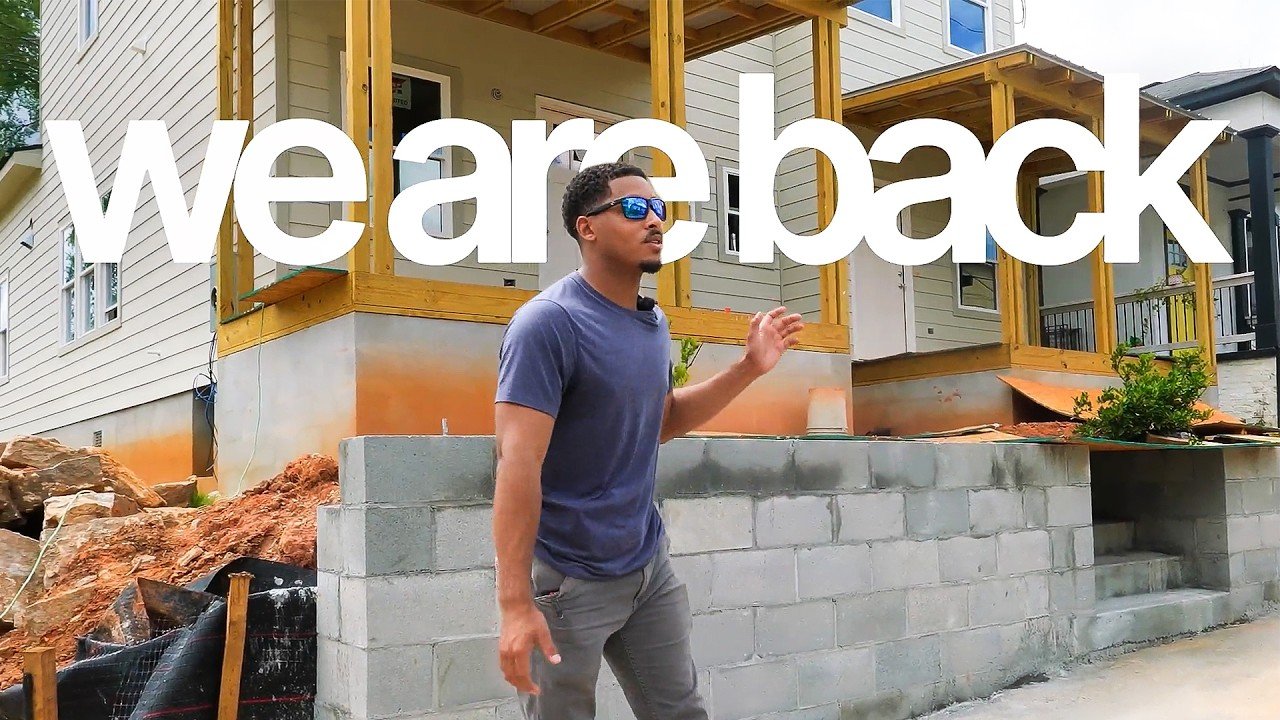 Corey walking past three duplexes under construction in Atlanta